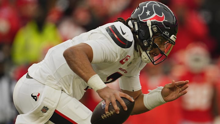 Houston Texans quarterback C.J. Stroud (7) scrambles with the ball against the Kansas City Chiefs during the second quarter of a 2025 AFC divisional round game at GEHA Field at Arrowhead Stadium.