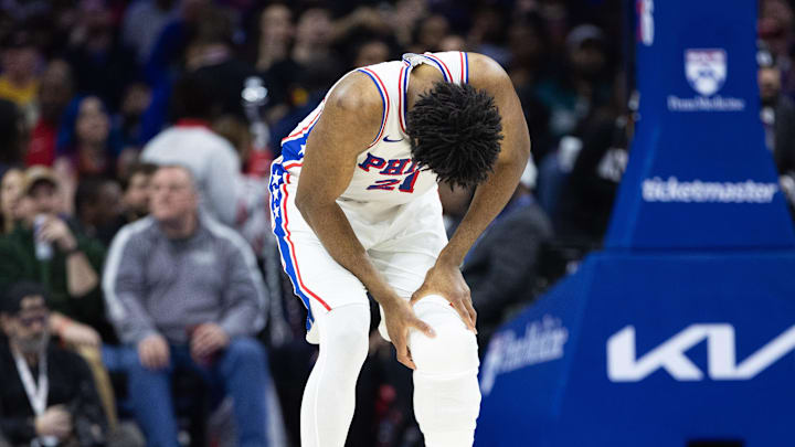 Feb 22, 2025; Philadelphia, Pennsylvania, USA; Philadelphia 76ers center Joel Embiid (21) holds his leg after a play against the Brooklyn Nets during the second quarter at Wells Fargo Center. Mandatory Credit: Bill Streicher-Imagn Images