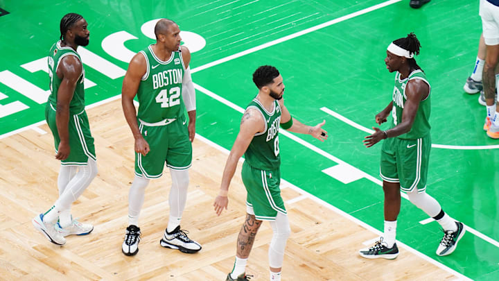 Jun 17, 2024; Boston, Massachusetts, USA; Boston Celtics forward Jayson Tatum (0) and guard Jrue Holiday (4) react in the second quarter against the Dallas Mavericks during game five of the 2024 NBA Finals at TD Garden. Mandatory Credit: David Butler II-Imagn Images