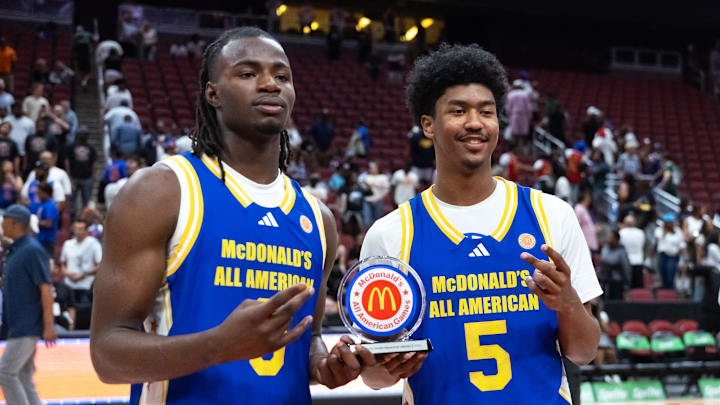 Caleb Holt (3) and Jason Crowe Jr (5) celebrate with the player of the game trophy following the McDonalds All American Boys Game at Desert Diamond Arena.