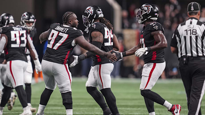Atlanta Falcons defensive end Jarrett reacts with defensive end Harris after a fourth down stop against the Dallas Cowboys during the second half at Mercedes-Benz Stadium. 