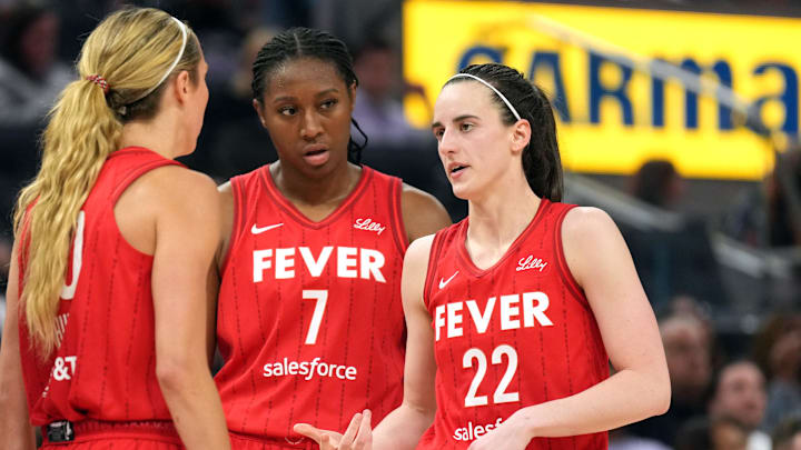 Jun 19, 2025; San Francisco, California, USA; Indiana Fever guard Caitlin Clark (22) talks to guard Lexie Hull (left) and forward Aliyah Boston (7) during the third quarter against the Golden State Valkyries at Chase Center. Mandatory Credit: Darren Yamashita-Imagn Images