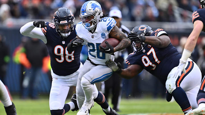 Montez Sweat and Andrew Billings attempt to stop Jahmyr Gibbs in last year's Bears win at Soldier Field.