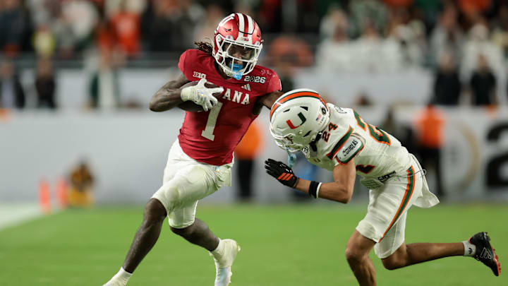Jan 19, 2026; Miami Gardens, FL, USA; Indiana Hoosiers running back Roman Hemby (1) carries the ball defended by Miami Hurricanes defensive back Ethan O'Connor (24) in the fourth quarter during the College Football Playoff National Championship game at Hard Rock Stadium. Mandatory Credit: Sam Navarro-Imagn Images