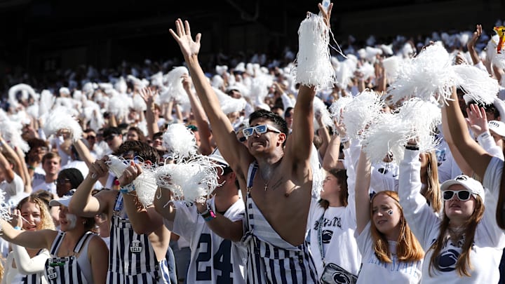 Penn State students cheer for the team during a game. Penn State students cheer for the team during a game.