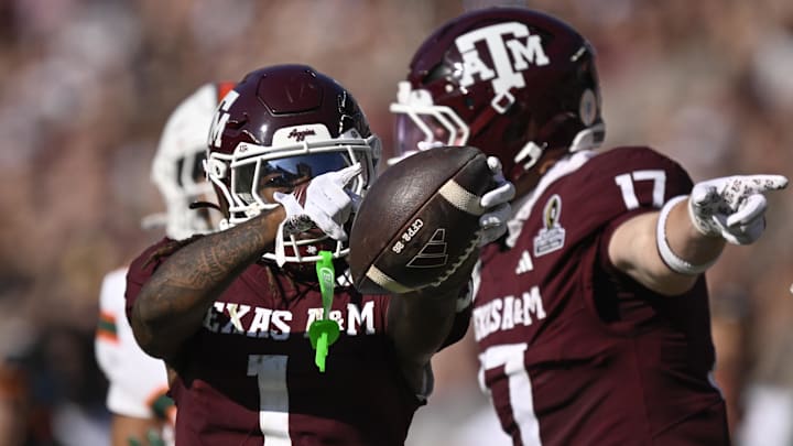 Texas A&M Aggies wide receiver Mario Craver and Texas A&M Aggies tight end Theo Melin Öhrström celebrate a first down against the Miami Hurricanes during the second half of the first round game of the CFP National Playoff at Kyle Field. 