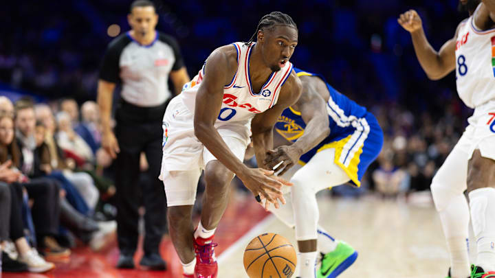 Mar 1, 2025; Philadelphia, Pennsylvania, USA; Philadelphia 76ers guard Tyrese Maxey (0) controls the ball against Golden State Warriors forward Draymond Green (23) during the fourth quarter at Wells Fargo Center. Mandatory Credit: Bill Streicher-Imagn Images