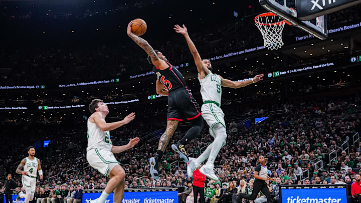 Jan 9, 2026; Boston, Massachusetts, USA; Toronto Raptors guard Alijah Martin (55) drives to the basket against Boston Celtics guard Derrick White (9) in the second half at TD Garden. Mandatory Credit: David Butler II-Imagn Images