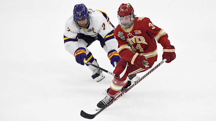 Apr 9, 2022; Boston, MA, USA; Denver Pioneers forward Carter Mazur (34) controls the puck in front