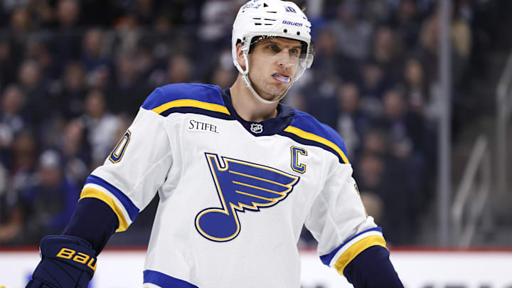 Apr 7, 2025; Winnipeg, Manitoba, CAN; St. Louis Blues center Brayden Schenn (10) looks on during a break in play against the Winnipeg Jets in the first period at Canada Life Centre. Mandatory Credit: James Carey Lauder-Imagn Images