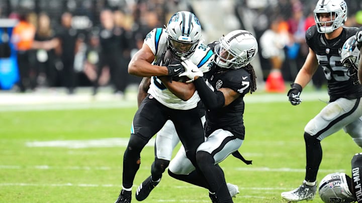 Sep 22, 2024; Paradise, Nevada, USA; Carolina Panthers running back Chuba Hubbard (30) attempts to break the tackle of Las Vegas Raiders safety Tre'von Moehrig (7) during the third quarter at Allegiant Stadium. Mandatory Credit: Stephen R. Sylvanie-Imagn Images Sep 22, 2024; Paradise, Nevada, USA; Carolina Panthers running back Chuba Hubbard (30) attempts to break the tackle of Las Vegas Raiders safety Tre'von Moehrig (7) during the third quarter at Allegiant Stadium. Mandatory Credit: Stephen R. Sylvanie-Imagn Images