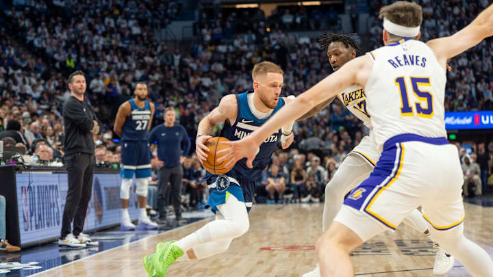 Minnesota Timberwolves guard Donte DiVincenzo drives to the basket defended by Los Angeles Lakers forward Dorian Finney-Smith and guard Austin Reaves (15) in the third quarter during Game 4 of their first-round playoff series at Target Center in Minneapolis on April 27, 2025.