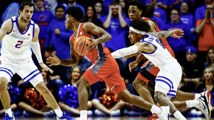 New Mexico guard Donovan Dent drives toward Boise State's Tyson Degenhart (2). 
