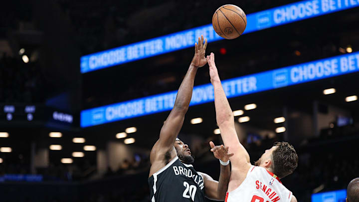 Jan 1, 2026; Brooklyn, New York, USA; Brooklyn Nets center Day'Ron Sharpe (20) shoots the ball as Houston Rockets center Alperen Sengun (28) defends during the first half at Barclays Center. Mandatory Credit: Vincent Carchietta-Imagn Images