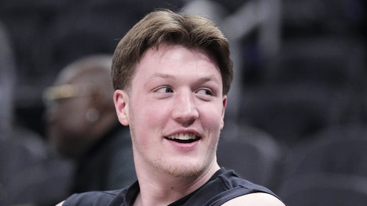 Jan 2, 2026; Milwaukee, Wisconsin, USA; Charlotte Hornets guard Kon Knueppel (7) watching his teammates warm up before a game against the Milwaukee Bucks at Fiserv Forum. Mandatory Credit: Michael McLoone-Imagn Images