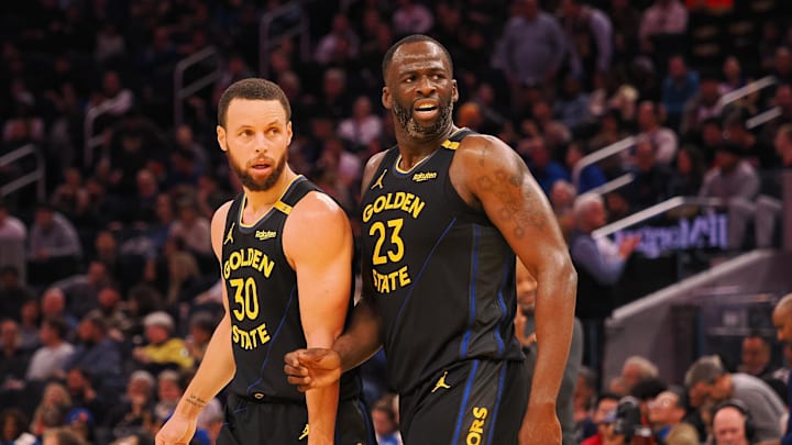 Feb 3, 2025; San Francisco, California, USA; Golden State Warriors guard Stephen Curry (30) and forward Draymond Green (23) look towards an Orlando Magic player at half time at Chase Center. Mandatory Credit: Kelley L Cox-Imagn Images
