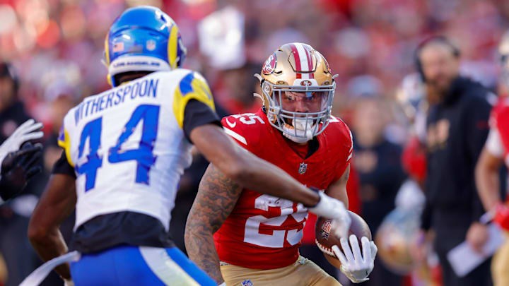 Jan 7, 2024; Santa Clara, California, USA; San Francisco 49ers running back Elijah Mitchell (25) runs with the ball during the second quarter Los Angeles Rams cornerback Ahkello Witherspoon (44) at Levi's Stadium.