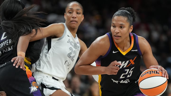 Aug 15, 2025; Phoenix, Arizona; Phoenix Mercury forward Alyssa Thomas (25) drives around Las Vegas Aces center A'ja Wilson (22) in the second half at Footprint Center. Aug 15, 2025; Phoenix, Arizona; Phoenix Mercury forward Alyssa Thomas (25) drives around Las Vegas Aces center A'ja Wilson (22) in the second half at Footprint Center.