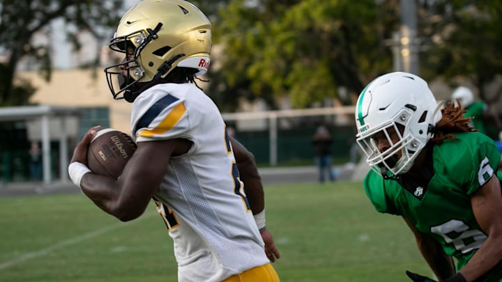 Jordan Lyle runs in a touchdown for St. Thomas Aquinas during their game against Fort Myers on