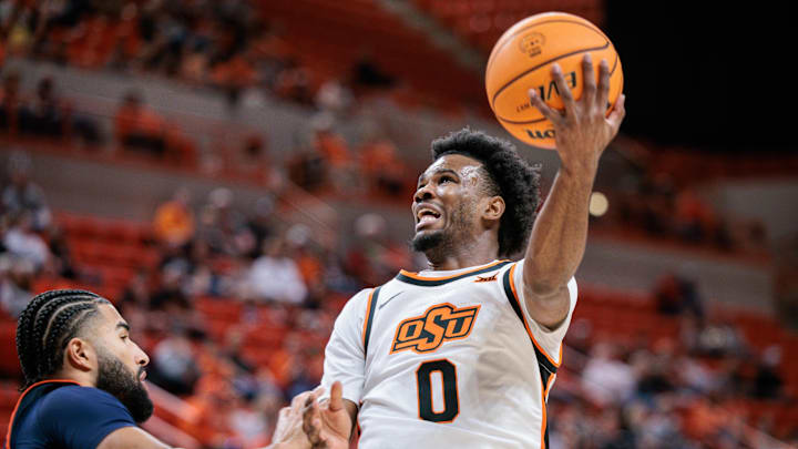 Dec 21, 2025; Stillwater, Oklahoma, USA; Oklahoma State Cowboys guard Jaylen Curry (0) shoots the ball during the first half against the Cal State Fullerton Titans at Gallagher-Iba Arena. Mandatory Credit: William Purnell-Imagn Images