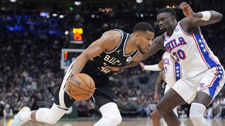 Jan 19, 2025; Milwaukee, Wisconsin, USA: Milwaukee Bucks forward Giannis Antetokounmpo (34) drives to the basket against Philadelphia 76ers center Adem Bona (30) in the first half at Fiserv Forum. Mandatory Credit: Michael McLoone-Imagn Images