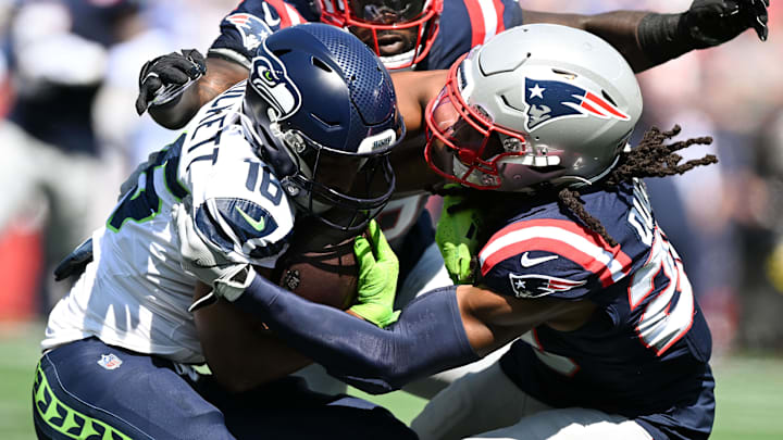  Sep 15, 2024; Foxborough, Massachusetts, USA; New England Patriots safety Kyle Dugger (23) tackles Seattle Seahawks wide receiver Tyler Lockett (16) during the first half at Gillette Stadium. Mandatory Credit: Brian Fluharty-Imagn Images