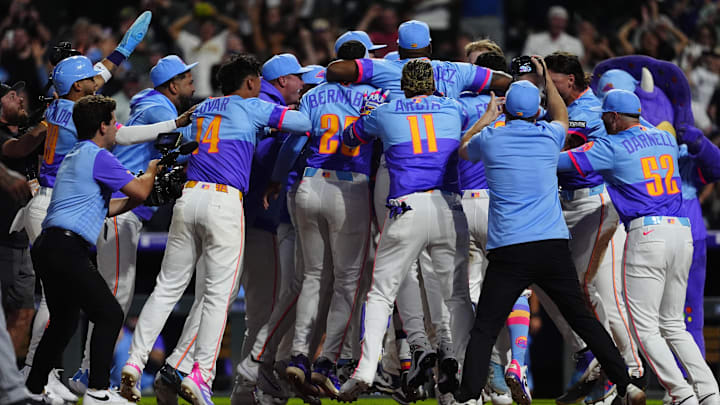 Aug 1, 2025; Denver, Colorado, USA; Members of the Colorado Rockies celebrate center fielder Brenton Doyle (9) (center) two run walk off home run in the ninth inning against the Pittsburgh Pirates at Coors Field. 