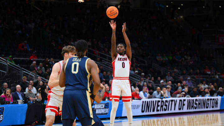 Mar 21, 2025; Seattle, WA, USA; Arizona Wildcats guard Jaden Bradley (0) shoots the ball against the Akron Zips during the first half in the first round of the NCAA Tournament at Climate Pledge Arena. Mandatory Credit: Steven Bisig-Imagn Images
