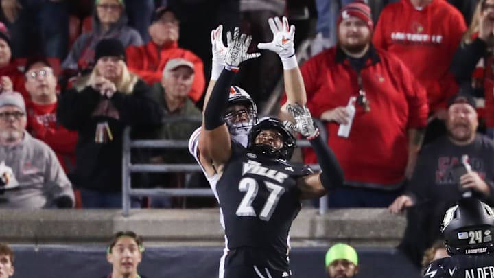 U of L's Devin Neal (27) broke up a touchdown pass attempt to Virginia's Grant Misch (85) during their game at the L&N Stadium in Louisville, Ky. on Nov. 9, 2023.