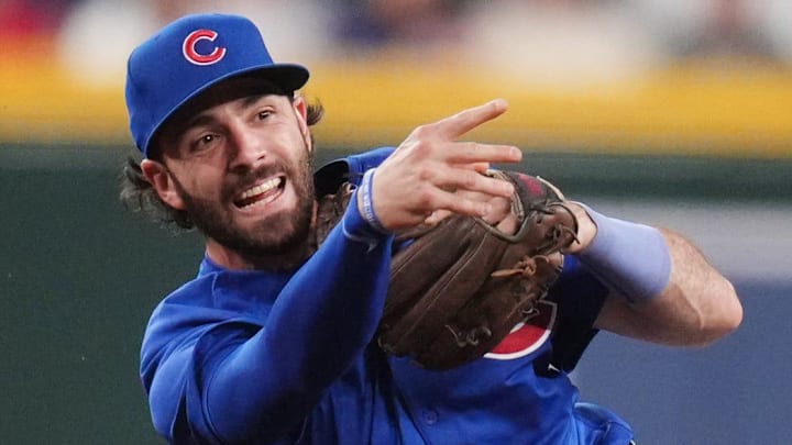 Chicago Cubs infielder Dansby Swanson (7) throws for the double play past Arizona Diamondbacks Corbin Carroll (7) during their Opening Day game at Chase Field in Phoenix on March 27, 2025