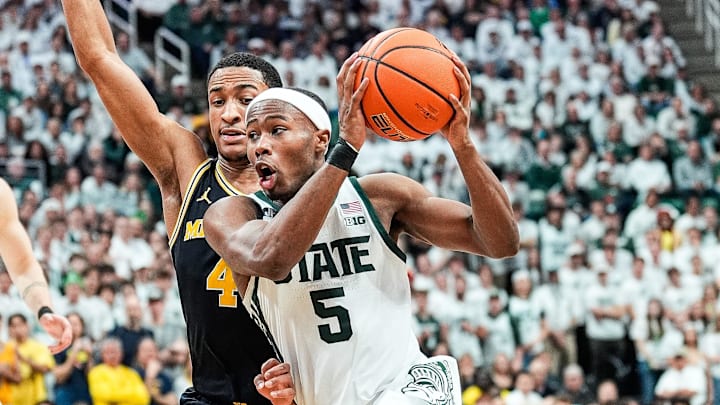 Michigan State guard Tre Holloman (5) dribbles against Michigan guard Nimari Burnett (4) during the second half at Breslin Center in East Lansing on Sunday, March 9, 2025. Michigan State guard Tre Holloman (5) dribbles against Michigan guard Nimari Burnett (4) during the second half at Breslin Center in East Lansing on Sunday, March 9, 2025.