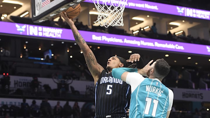 Orlando Magic forward Paolo Banchero (5) drives to the basket as he is defended by Charlotte Hornets center Jusuf Nurkic (11) during the first half at the Spectrum Center.