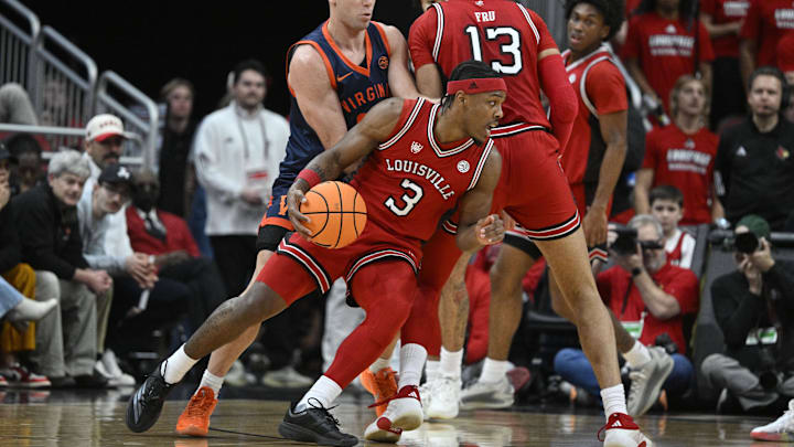 Jan 13, 2026; Louisville, Kentucky, USA;  Louisville Cardinals guard Ryan Conwell (3) dribbles around the screen of forward Sananda Fru (13) against Virginia Cavaliers guard Dallin Hall (30) during the first half at KFC Yum! Center. Mandatory Credit: Jamie Rhodes-Imagn Images