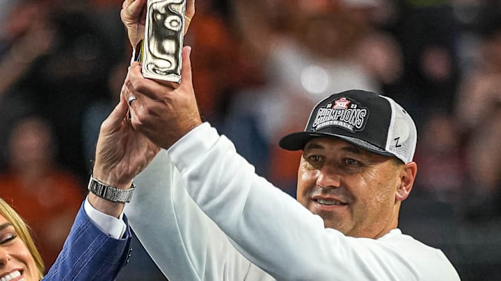 Texas Longhorns head coach Steve Sarkisian holds up the Big 12 Championship trophy after the 49-21 win over the Oklahoma State Cowboys at AT&T stadium on Saturday, Dec. 2, 2023 in Arlington.