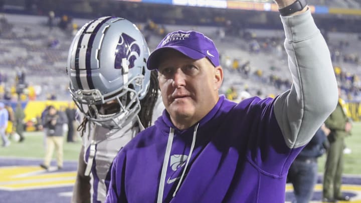 Oct 19, 2024; Morgantown, West Virginia, USA; Kansas State Wildcats head coach Chris Klieman celebrates with fans after defeating the West Virginia Mountaineers at Mountaineer Field at Milan Puskar Stadium. Mandatory Credit: Ben Queen-Imagn Images Oct 19, 2024; Morgantown, West Virginia, USA; Kansas State Wildcats head coach Chris Klieman celebrates with fans after defeating the West Virginia Mountaineers at Mountaineer Field at Milan Puskar Stadium. Mandatory Credit: Ben Queen-Imagn Images