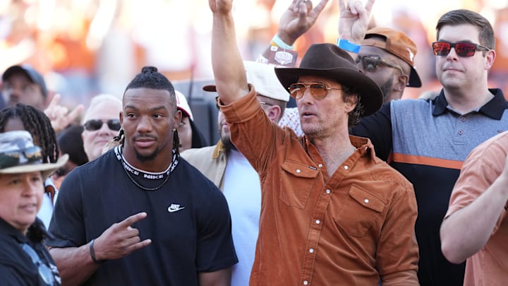 Nov 23, 2024; Austin, Texas, USA; Former Texas Longhorn and Atlanta Falcons running back Bijan Robinson and actor Matthew McConaughey hold up their horns before a game against the Kentucky Wildcats at Darrell K Royal-Texas Memorial Stadium. Mandatory Credit: Scott Wachter-Imagn Images