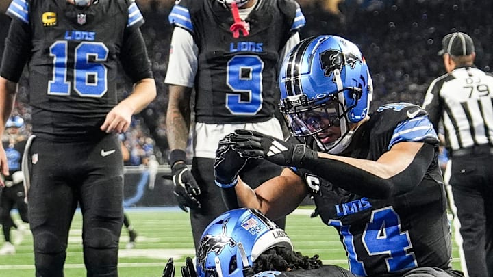 Detroit Lions running back Jahmyr Gibbs (26), center, celebrates his fourth touchdown of the day with teammates include wide receiver Amon-Ra St. Brown (14) during the second half against Minnesota Vikings at Ford Field in Detroit on Sunday, Jan. 5, 2025.
