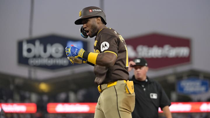 Oct 6, 2024; Los Angeles, California, USA; San Diego Padres outfielder Jurickson Profar (10) reacts at first base after bunting in the sixth inning against the Los Angeles Dodgers during game two of the NLDS for the 2024 MLB Playoffs at Dodger Stadium. Mandatory Credit: Jayne Kamin-Oncea-Imagn Images