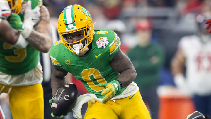 Jan 1, 2024; Glendale, AZ, USA; Oregon Ducks running back Bucky Irving (0) against the Liberty Flames during the 2024 Fiesta Bowl at State Farm Stadium.