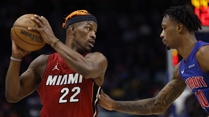 Dec 16, 2024; Detroit, Michigan, USA;  Miami Heat forward Jimmy Butler (22) controls the ball as Detroit Pistons forward Ronald Holland II (00) defends in the first half at Little Caesars Arena. Mandatory Credit: Rick Osentoski-Imagn Images
