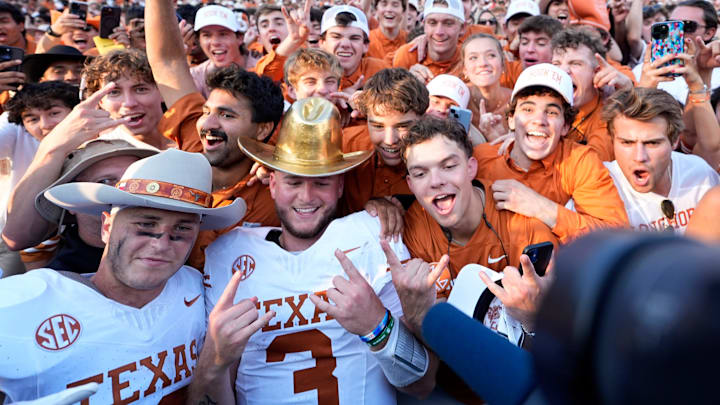 Texas Longhorns quarterback Quinn Ewers (3) and Michael Taaffe (16) celebrate following the Red River Rivalry college football game against the University of Oklahoma Sooners.