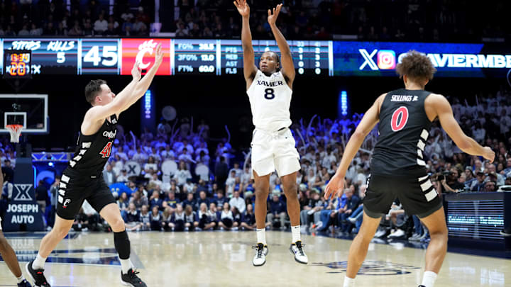 Xavier Musketeers guard Quincy Olivari (8) rises for a 3-point basket in the second half of the 91st Crosstown Shootout basketball game between the Cincinnati Bearcats and the Xavier Musketeers, Saturday, Dec. 9, 2023, at Cintas Center in Cincinnati. The Xavier Musketeers won, 84-79.