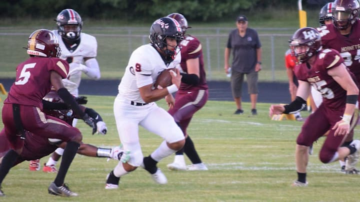 Bellefontaine's Tavien St. Clair breaks into the center of the Licking Heights defense during the host Hornets' 45-14 loss on Friday, Sept. 1, 2023.