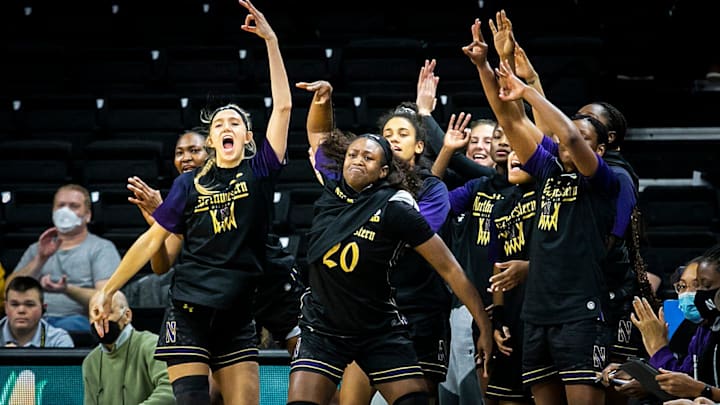 Northwestern Women’s Basketball teammates celebrate on the bench