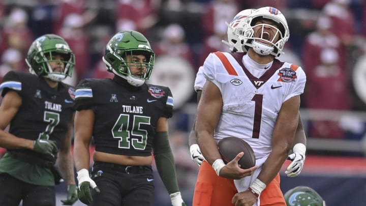 Dec 27, 2023; Annapolis, MD, USA;  Virginia Tech Hokies quarterback Kyron Drones (1) reacts after running for a first down against the Tulane Green Wave at Navy-Marine Corps Memorial Stadium. Mandatory Credit: Tommy Gilligan-USA TODAY Sports