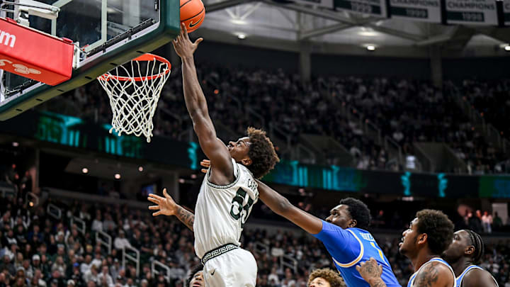 Michigan State's Coen Carr, left, scores against UCLA's Xavier Booker during the first half on Tuesday, Feb. 17, 2026, at the Breslin Center in East Lansing.