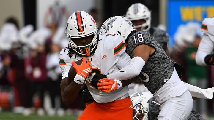 Nov 22, 2025; Blacksburg, Virginia, USA; Miami (FL) Hurricanes wide receiver Joshua Moore (3) runs after a catch as Virginia Tech Hokies safety Isaiah Cash (18) attempts to tackle during the second quarter at Lane Stadium. Mandatory Credit: Brian Bishop-Imagn Images
