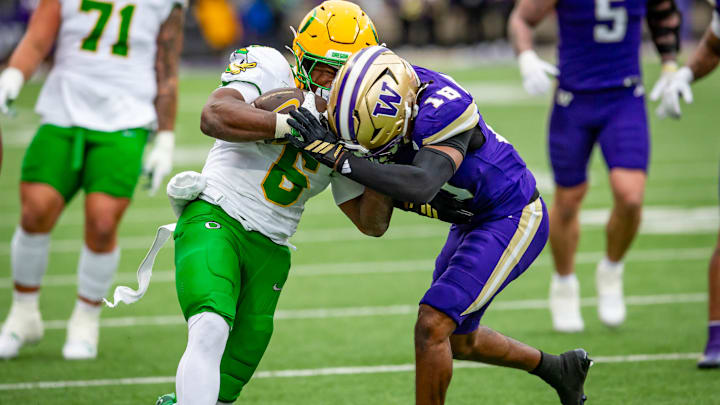 Rylon "Batman" Dillard-Allen slams into Oregon running back Noah Whittington. 