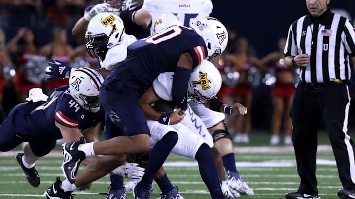 Sep 2, 2023; Tucson, Arizona, USA; Arizona Wildcats defensive lineman Isaiah Ward (90) makes a tackle agaisnt Northern Arizona Lumberjacks quarterback Niko Haen (12) during the second half at Arizona Stadium. Mandatory Credit: Zac BonDurant-USA TODAY Sports