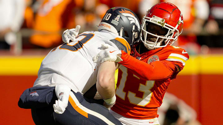 Nov 10, 2024; Kansas City, Missouri, USA; Denver Broncos quarterback Bo Nix (10) is sacked by Kansas City Chiefs safety Nazeeh Johnson (13) during the first half at GEHA Field at Arrowhead Stadium. 